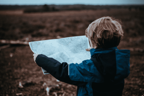A child trying to relate a map to the landscape ahead.